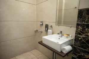 a bathroom with a white sink and a shower at Dalhousie Hotel in Dalhousie