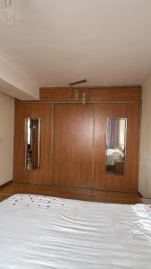 a bedroom with a bed and a wooden wall at Near ASA Arena Circus in Ulaanbaatar