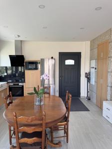 a kitchen and dining room with a wooden table at Quinta do Olival Amarante in Gatão