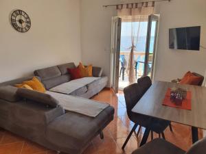 a living room with a couch and a table at Villa-Panorama in Drage