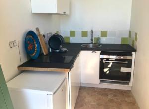 a small kitchen with a sink and a stove at Beautiful studio with a beautiful view in Lurs