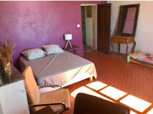 a bedroom with a bed and a chair in a room at Beautiful studio with a beautiful view in Lurs