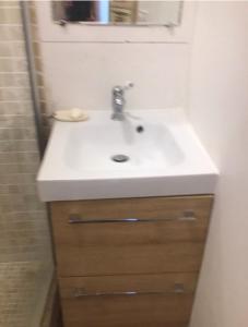 a bathroom with a white sink and a shower at Beautiful studio with a beautiful view in Lurs
