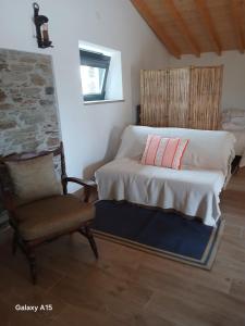 a bedroom with a bed and a chair in a room at Casa da Eira in Pinheiro de Coja +17 photos