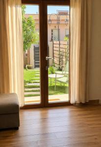 an open door with a view of a patio at Su Entu Suite Free Parking 5 min from the sea in Giba