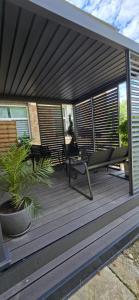 a wooden deck with a table and chairs on it at Lumina Residence Našice in Našice