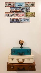 a pile of luggage sitting on top of a table at Domus Rubra in Castelsardo