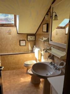a bathroom with a sink and a toilet at VACANZE A SESTOLA in Sestola +40 photos