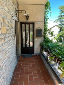 a front door of a house with a brick walkway at VACANZE A SESTOLA in Sestola