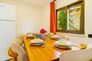 a dining room with a wooden table and chairs at Summerdays in the Med in Fethiye