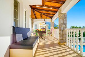 a porch with a couch on a house at Summerdays in the Med in Fethiye