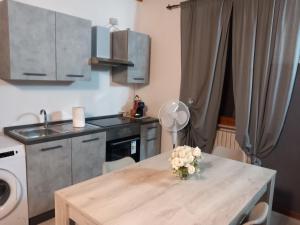 a kitchen with a table with a vase of flowers on it at appartamento in Ponte San Marco