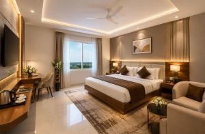 a large hotel room with a bed and a desk at Hotel Velocity Near Terminal 3 Delhi International Airport With- Free Pickup in New Delhi