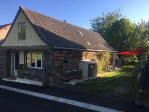 a stone house with a red roof and a yard at La grange de Maurines in Maurines