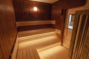 a small sauna with wooden paneling and a window at Oarai Park Hotel in Oarai +45 photos
