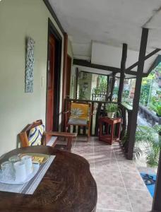 a dining room with a table and chairs at Ennas Place guest house in Coron