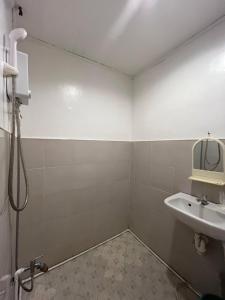 a bathroom with a sink and a mirror at Ennas Place guest house in Coron