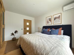 a bedroom with a large bed with blue pillows at Rooftop Spa Villa Kuressaare in Kuressaare