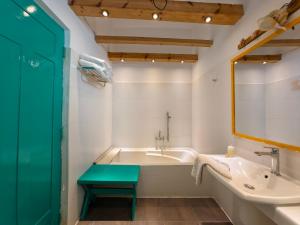 a bathroom with a tub and a sink and a mirror at Trinco Beach by DSK in Trincomalee +58 photos