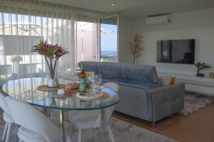 a living room with a couch and a glass table at Luxury by the Blue in Vila Nova de Gaia