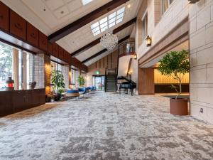 an empty lobby with a grand piano in a building at Oarai Park Hotel in Oarai