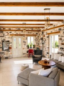 a living room with a stone wall at Aphrodite's Villa in Ambelas +144 photos