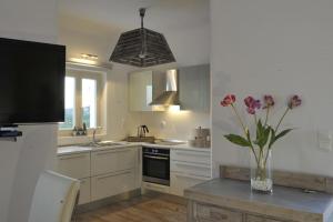 a kitchen with a vase of flowers on a table at Chrysalis Nature Villa 4 in Kampos Paros
