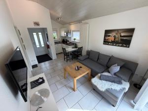 a living room with a couch and a table at Ferienhaus Burbach in Burbach