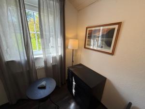 a room with a television and a chair and a window at Ferienhaus Burbach in Burbach
