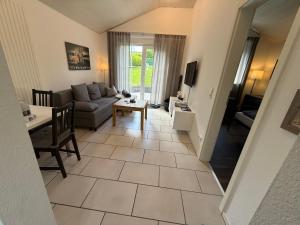 a living room with a couch and a table at Ferienhaus Burbach in Burbach