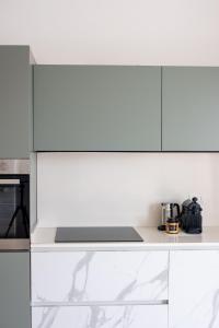 a kitchen with white cabinets and a counter top at Ca'vio Beach Pool in Cavallino-Treporti