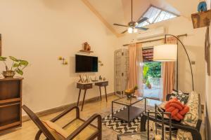 a living room with a couch and a tv at Luxury 2BHK Villa Near Anjuna Beach, North Goa in Anjuna