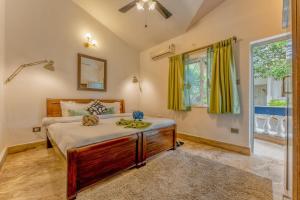 a bedroom with a large bed and a window at Luxury 2BHK Villa Near Anjuna Beach, North Goa in Anjuna +23 photos