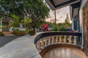 a balcony of a house with plants on it at Luxury 2BHK Villa Near Anjuna Beach, North Goa in Anjuna