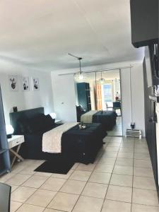 a bedroom with a bed and a couch in it at Angel's Cottage Unit 2 in Paarl