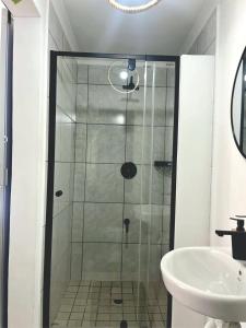 a glass shower in a bathroom with a sink at Angel's Cottage Unit 2 in Paarl