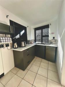 a kitchen with a sink and a counter top at Angel's Cottage Unit 2 in Paarl