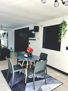 a dining room with a blue table and chairs at Angel's Cottage Unit 2 in Paarl +3 photos