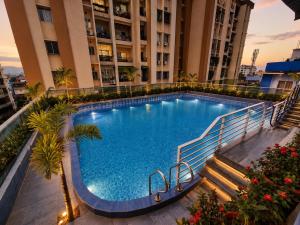 a large swimming pool in the middle of a building at Hotel Banyan Courtyard Guwahati in Guwahati