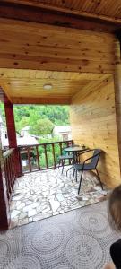 a patio with a table and chairs on a porch at Guest House Waterfall in Mazeri
