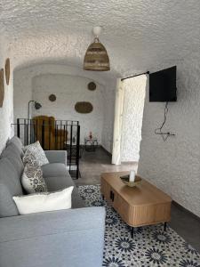 a living room with a couch and a table at Cueva Pilar in Graena
