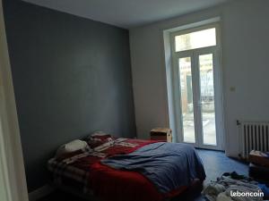 a bedroom with a bed in front of a window at Appartement avec terrasse 42m2 in Saint-Martin-de-Valamas
