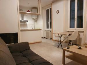 a living room with a couch and a table at Appartement avec terrasse 42m2 in Saint-Martin-de-Valamas
