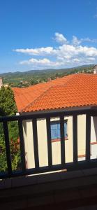 a building with an orange roof with a view at Hill View in Nikiti