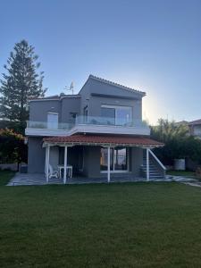 a large house with a lawn in front of it at Seafront Apartment in Skala Mistegnon