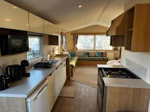 a kitchen with a counter top and a living room at The Springs 22-Sara in Winthorpe
