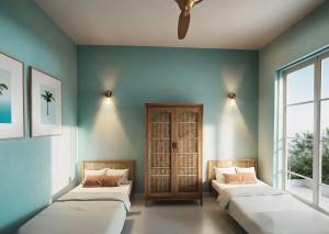 two beds in a room with blue walls and windows at SUWA CHANDU - By Mountain Boutiques Luxury Collection in Mirissa +1 photo