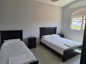 a bedroom with two beds and a window at Andalus Sunset in Tangier