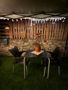 a table and chairs in a tent with a plant on it at La Somavan Tambu in Xàtiva