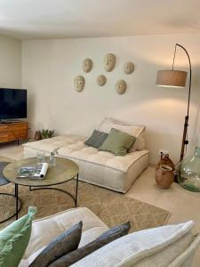 a living room with a couch and a table at La Bastide Chamarrée in Camaret-sur-Aigues